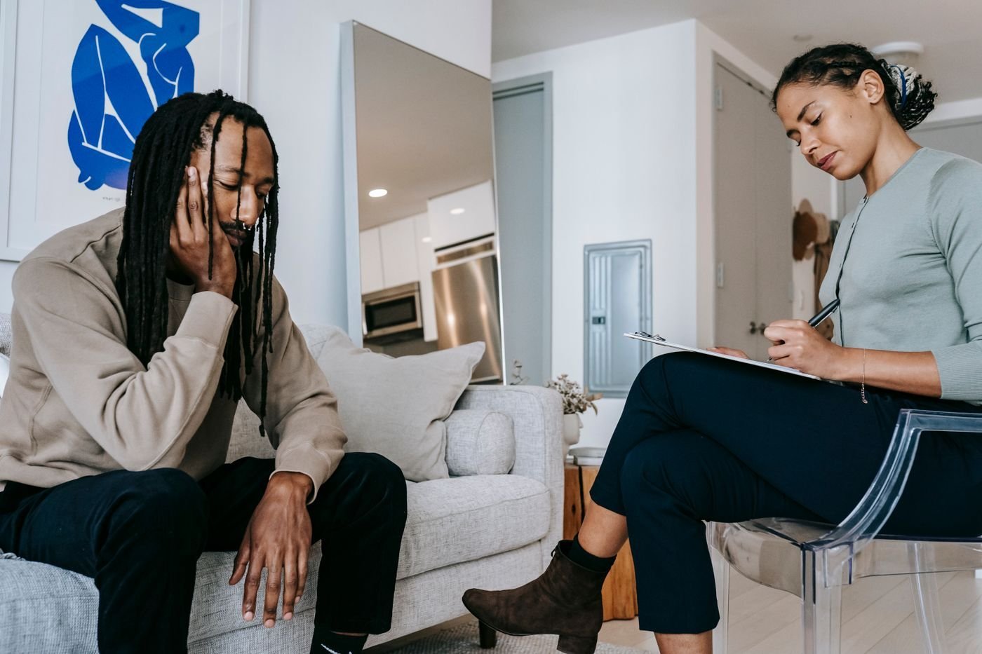 An adult client speaking with a therapist