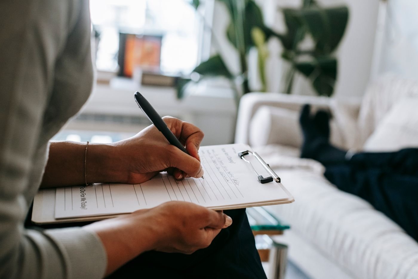 A therapist taking notes during a session