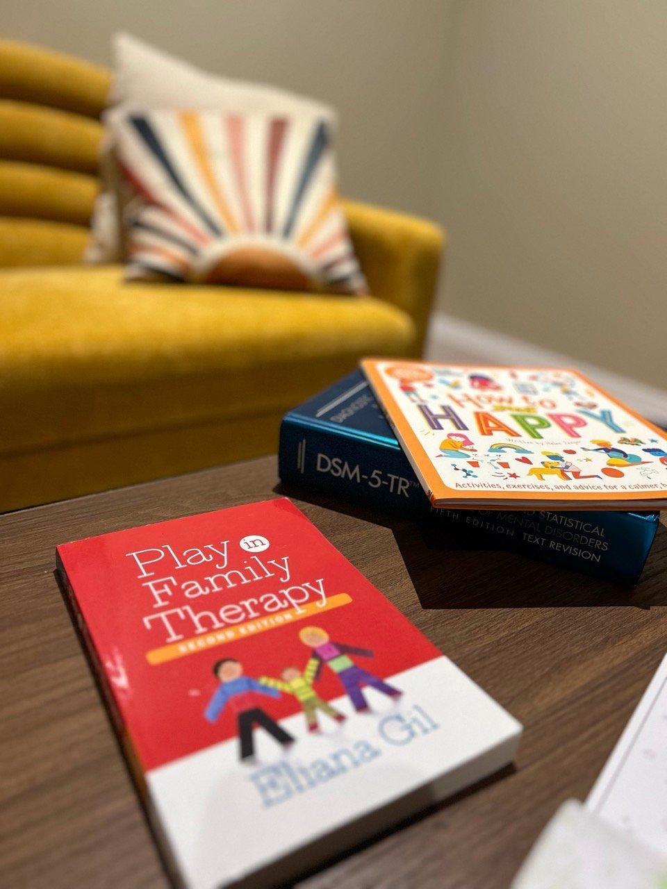 Play and Family Therapy book on the therapy room table