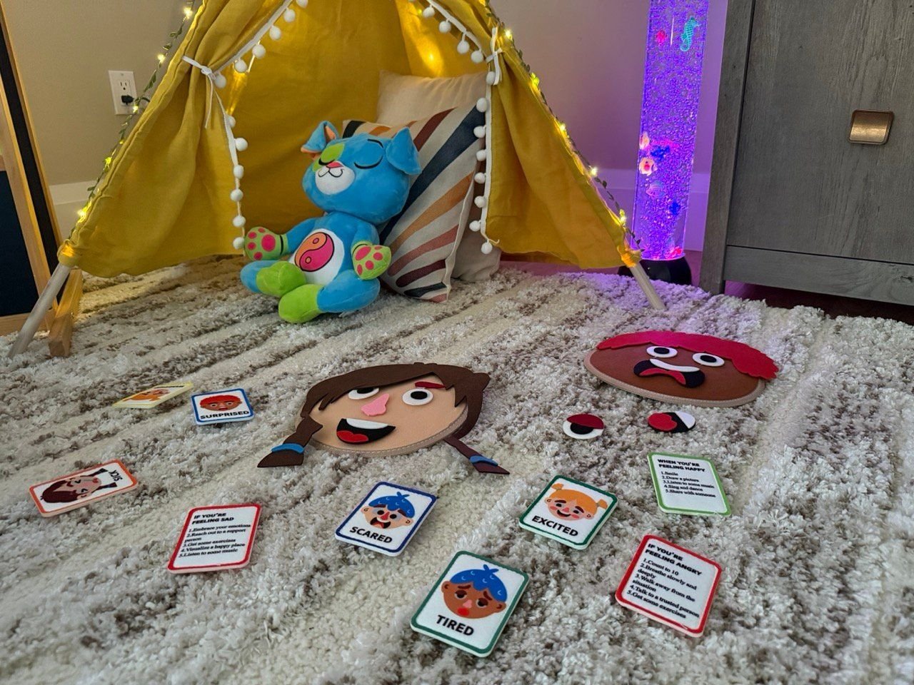 Feelings faces and cards on the floor by the tent
