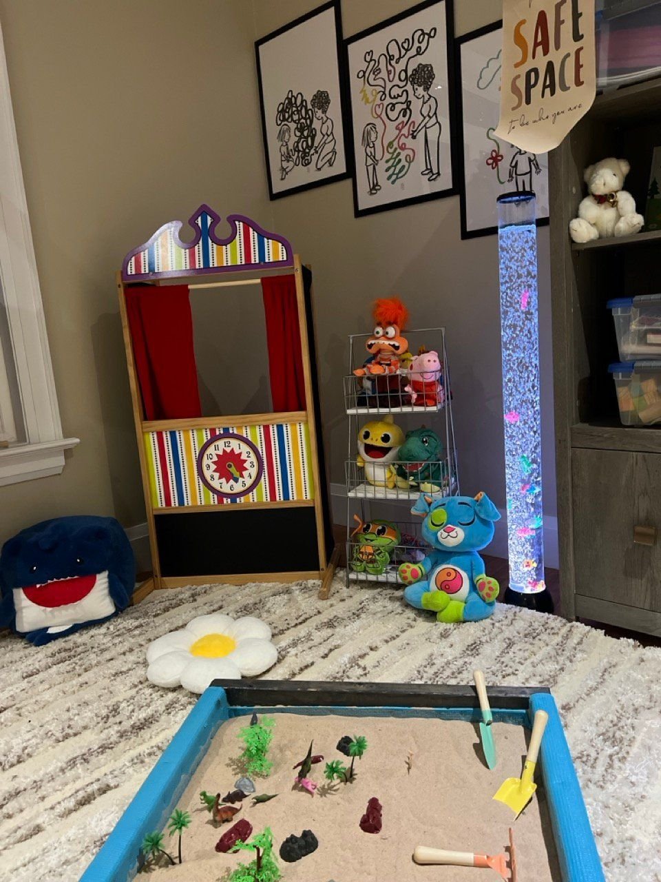 The sand tray and puppet theatre in the play room