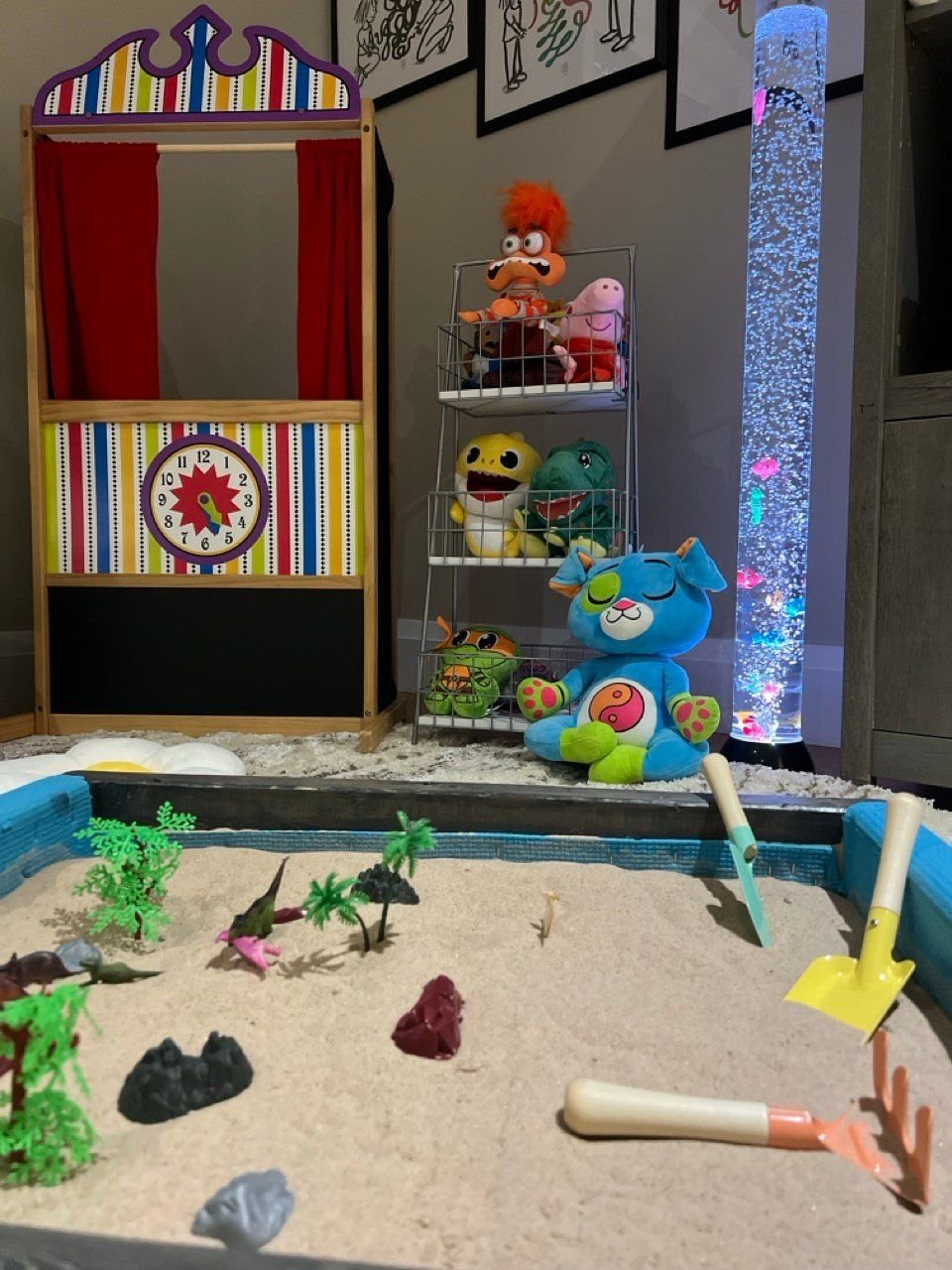 A sand tray with figures in front of the puppet theatre