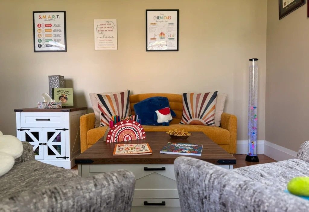 A cozy sofa with cushions and a bubble lamp in the therapy room