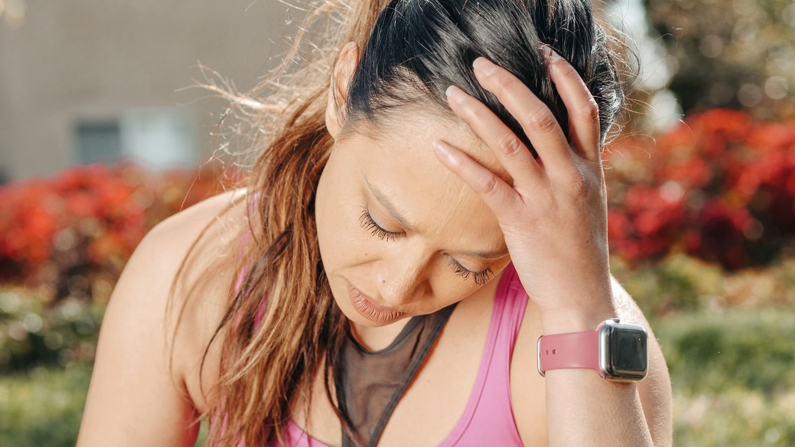 Athlete holding her head after training
