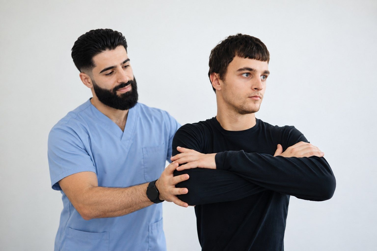 Arman Moshkelani guiding a patient through a shoulder stretch
