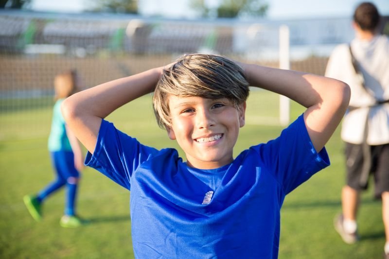 Smiling boy on a soccer field
