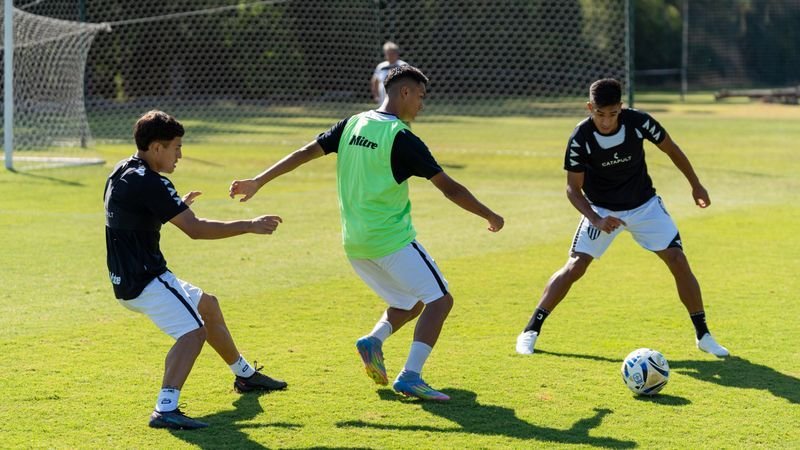 Teen soccer players training on a field