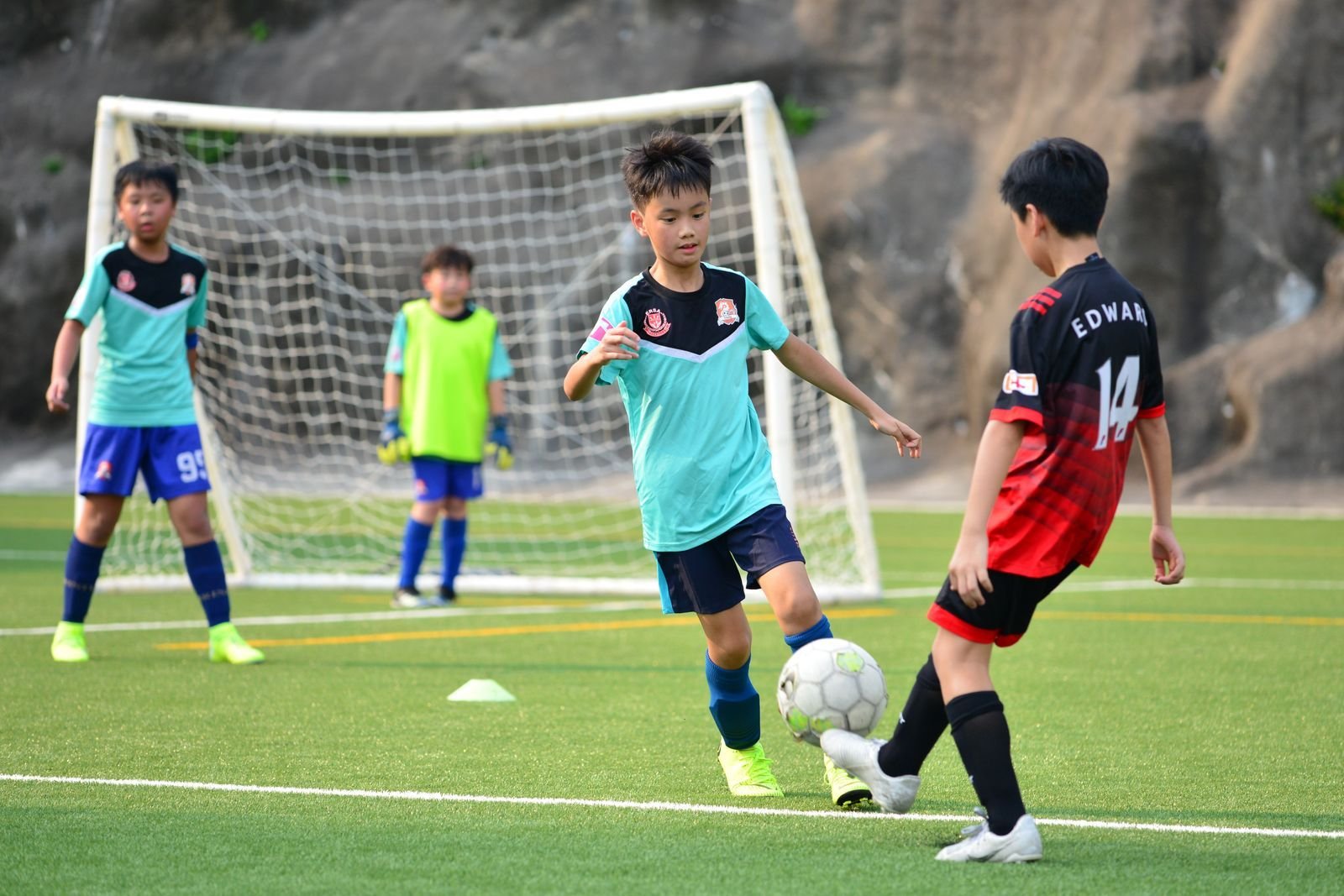 Young soccer players competing for the ball