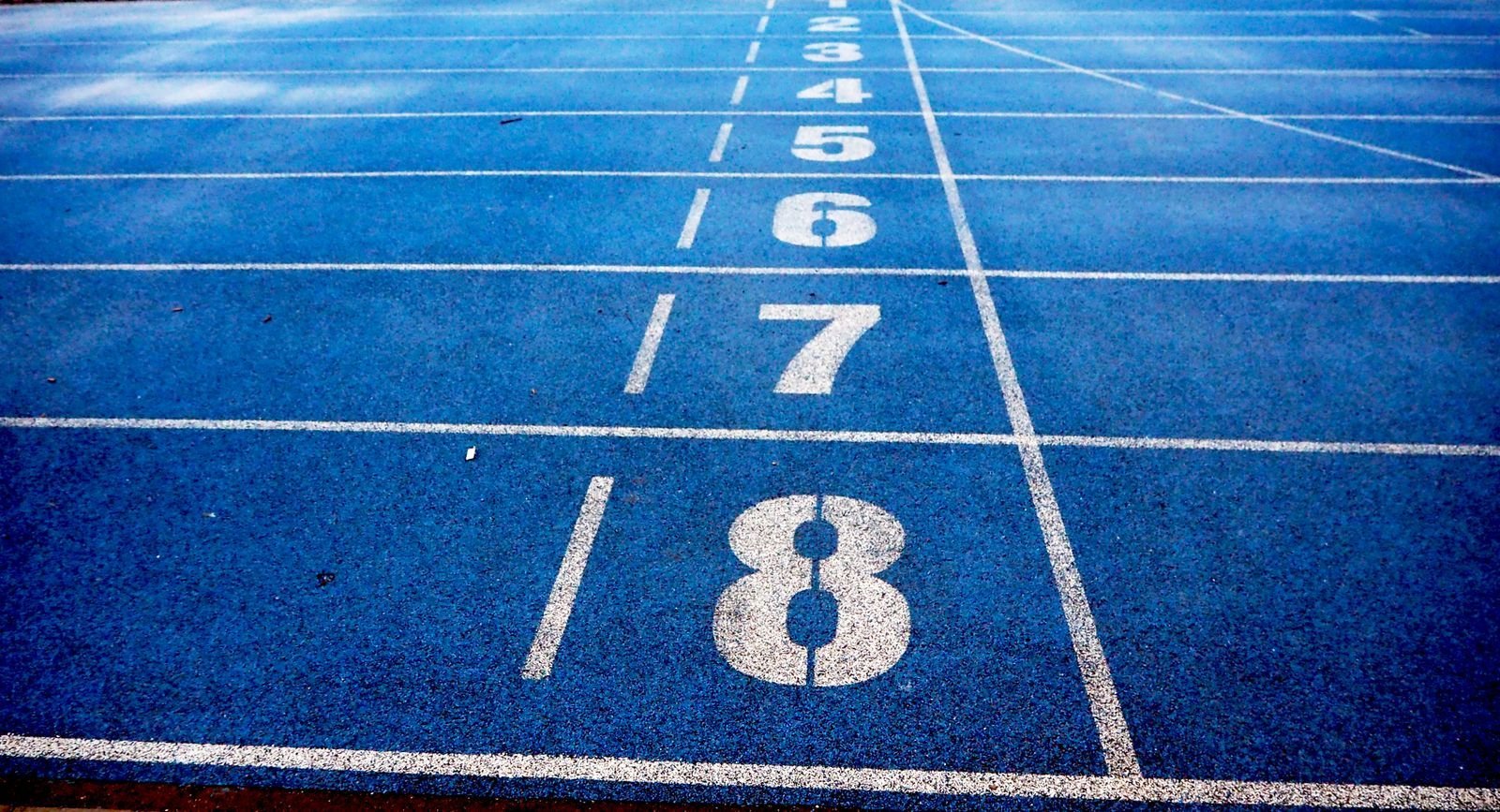 Blue running track with numbered lanes