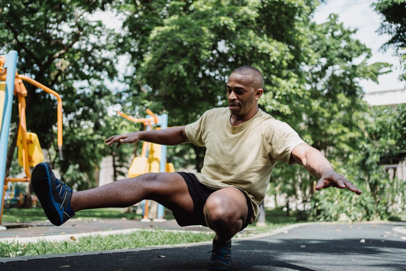 Man performing a single-leg balance exercise outdoors